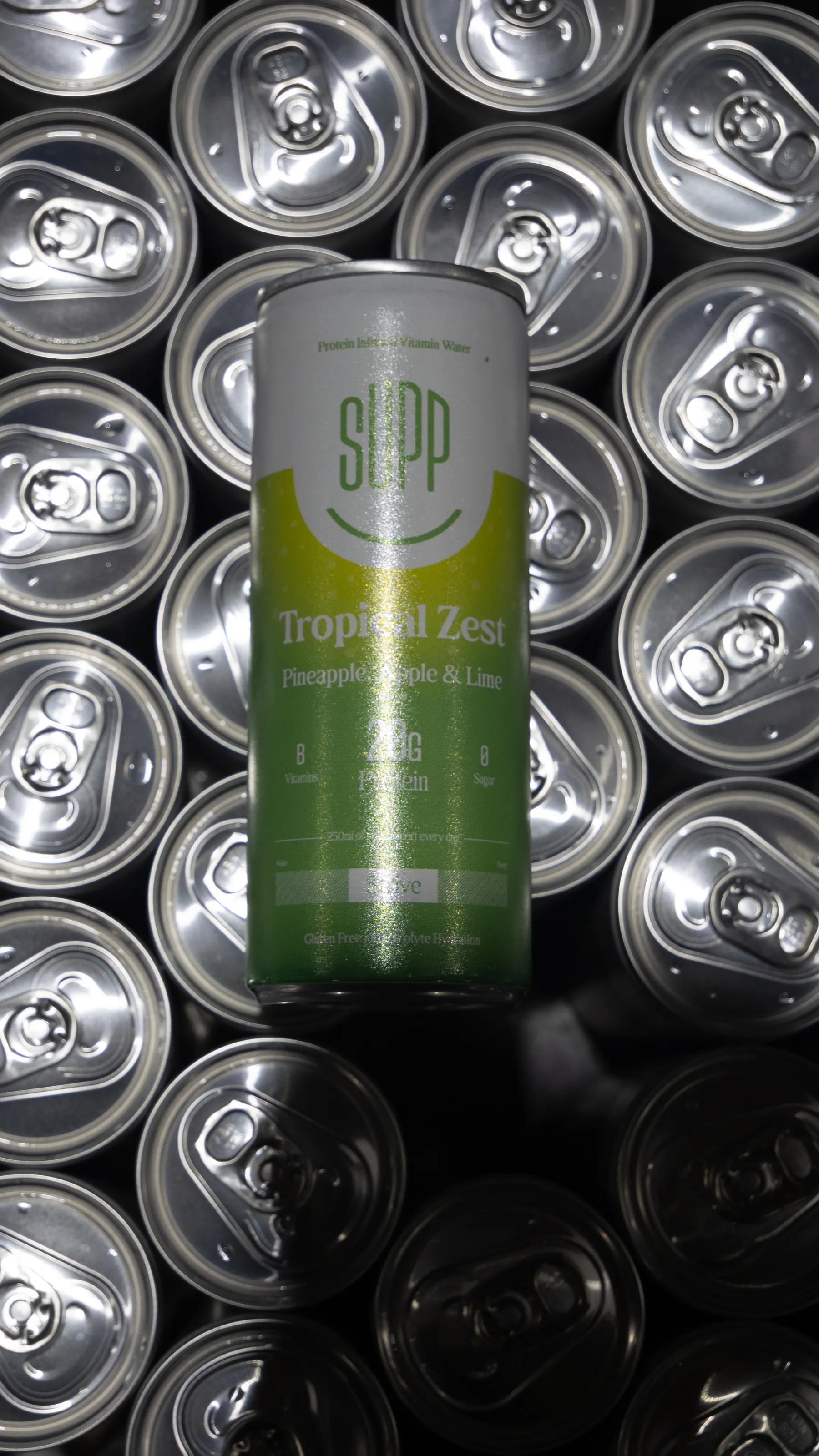 Supp Tropical Zest can lying on a bed of silver can tops and ring pulls
